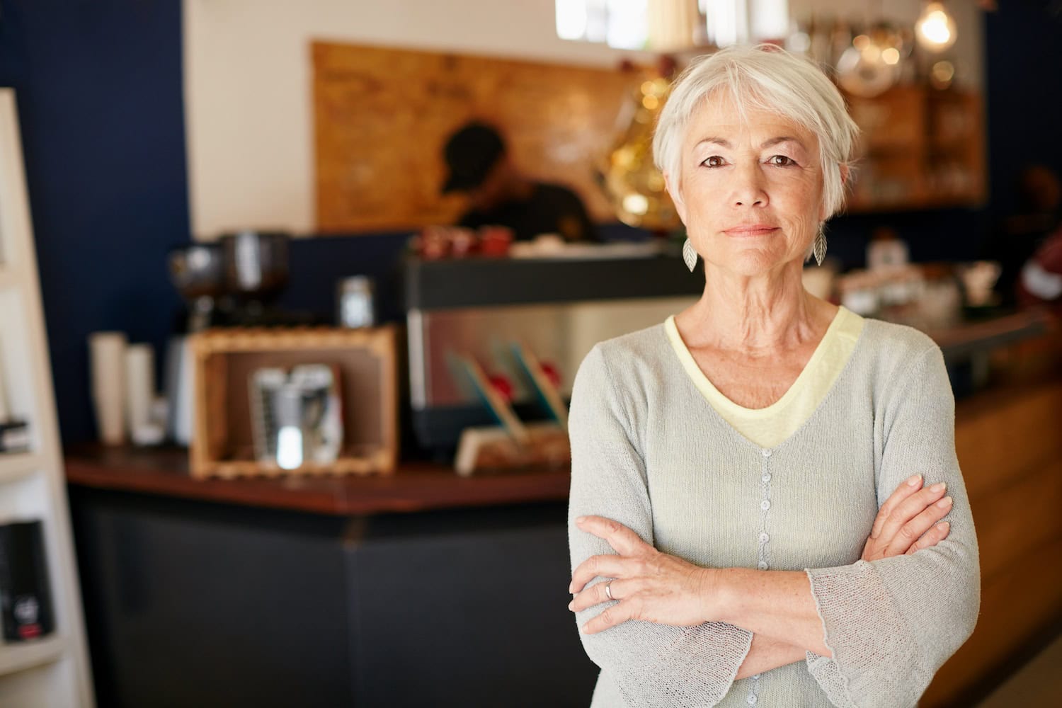 Portrait of a senior woman working in a coffee shop.