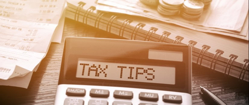 A closeup of a calculator reads "tax tips" on the screen
