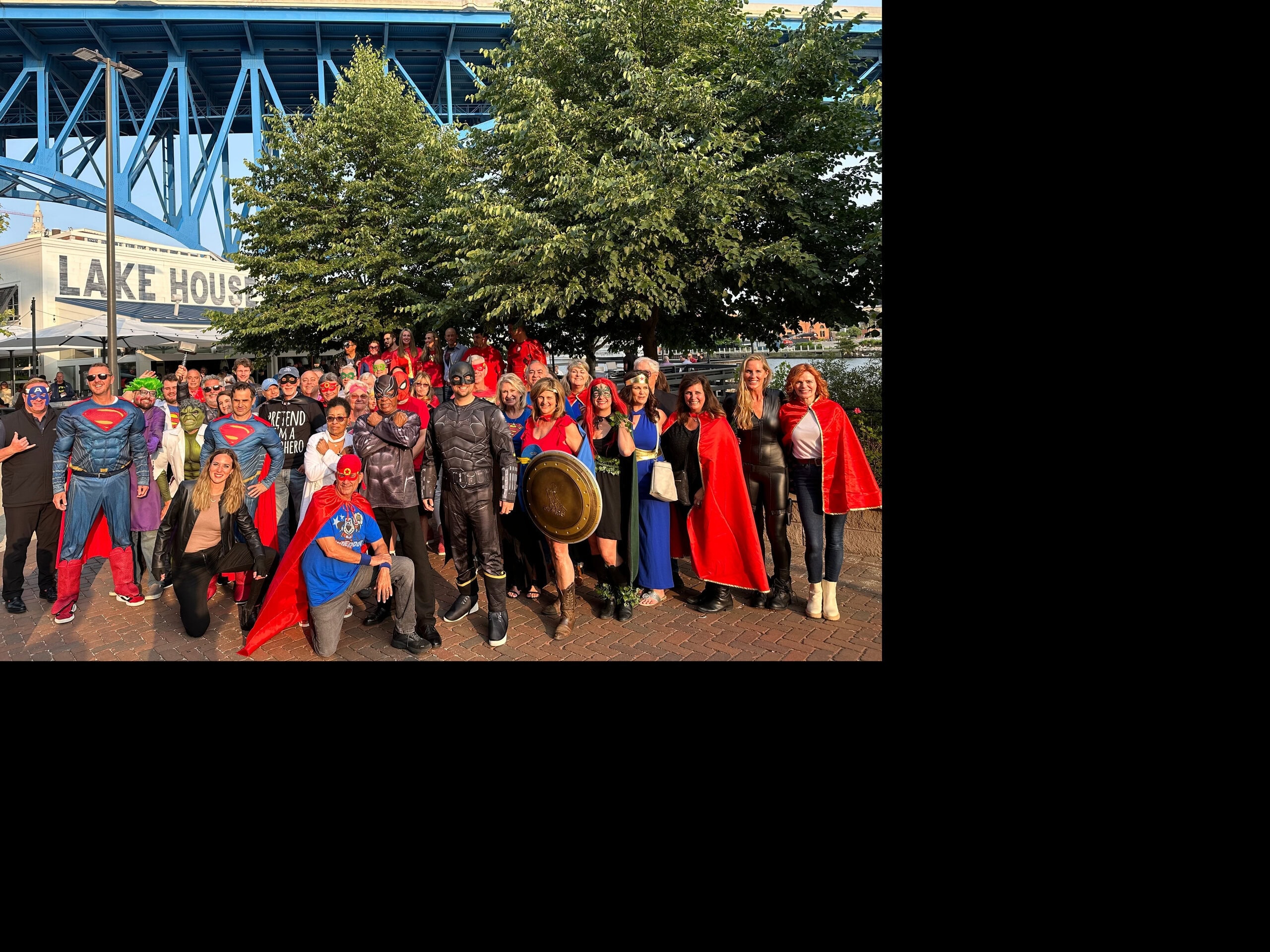 Costume-clad guests of C2P’s Mastermind Collegium 2023 gathered for a group superhero photo at Lindey’s Lake House Flats