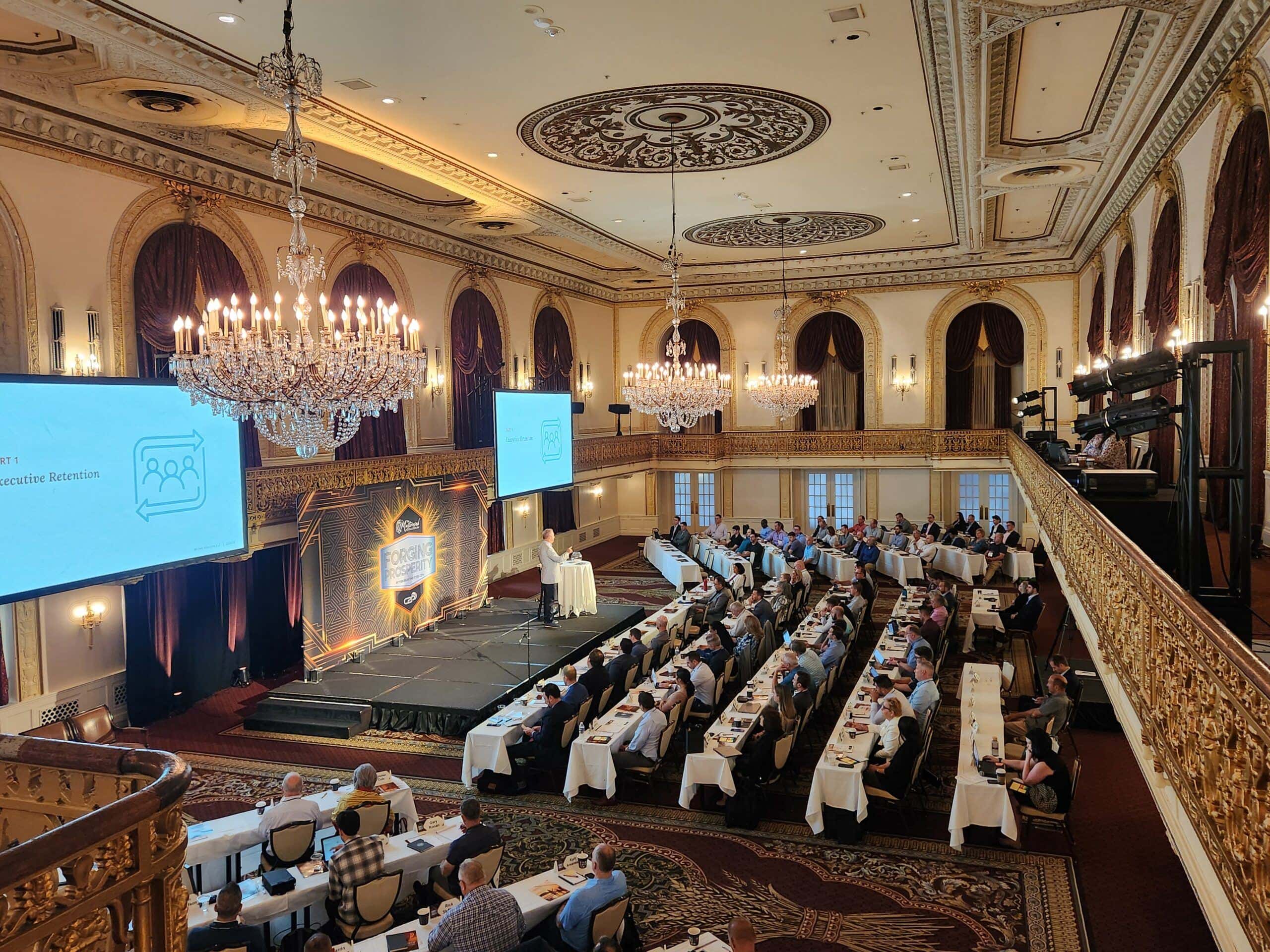 Jim Erben presents to a historic ballroom full of engaged advisors at the 2024 MMC, hosted by C2P at Pittsburgh’s Omni William Penn Hotel.
